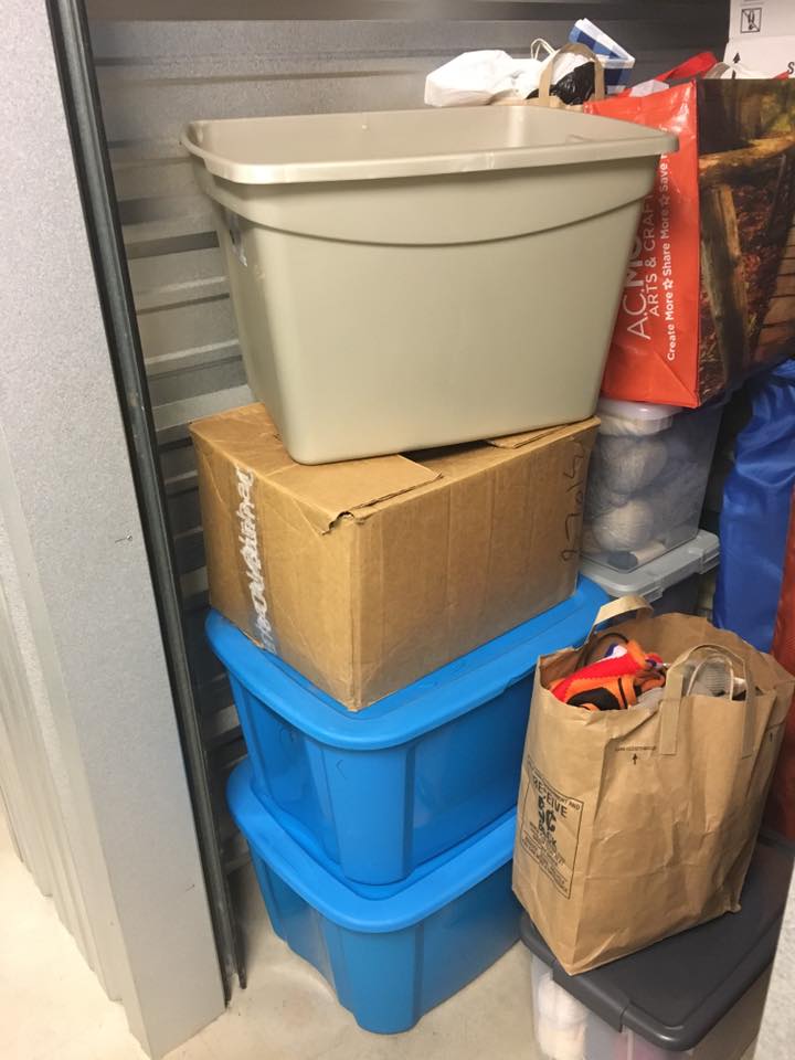 Bins and bags of scarves and yarn donated to WUP.